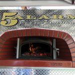 brick oven cooking pizza